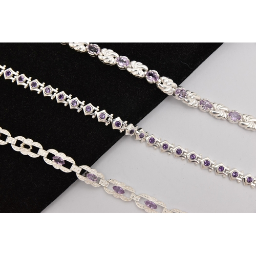 450 - THREE WHITE METAL GEM SET LINE BRACELETS, different designs, all set with amethysts, fitted with int... 