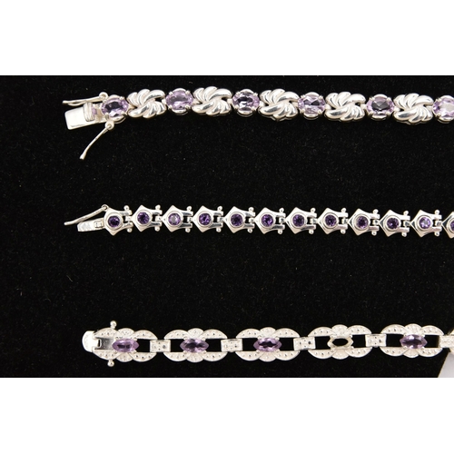 450 - THREE WHITE METAL GEM SET LINE BRACELETS, different designs, all set with amethysts, fitted with int... 