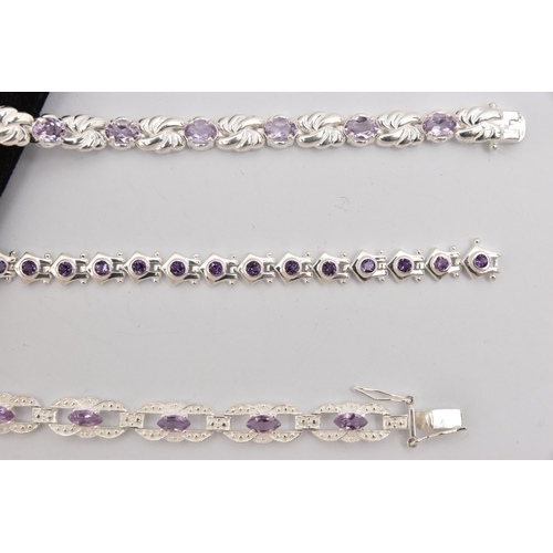 450 - THREE WHITE METAL GEM SET LINE BRACELETS, different designs, all set with amethysts, fitted with int... 