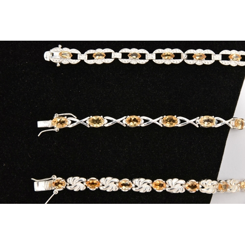 451 - THREE WHITE METAL GEM SET LINE BRACELETS, different designs, all set with Citrine, fitted with integ... 