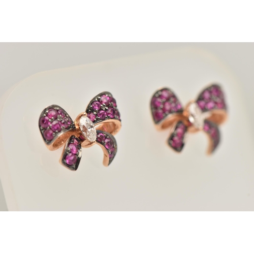 455 - A PAIR OF MODERN GEM SET EARRINGS, a pair of rose metal earrings designed as bows, pave set with cir... 