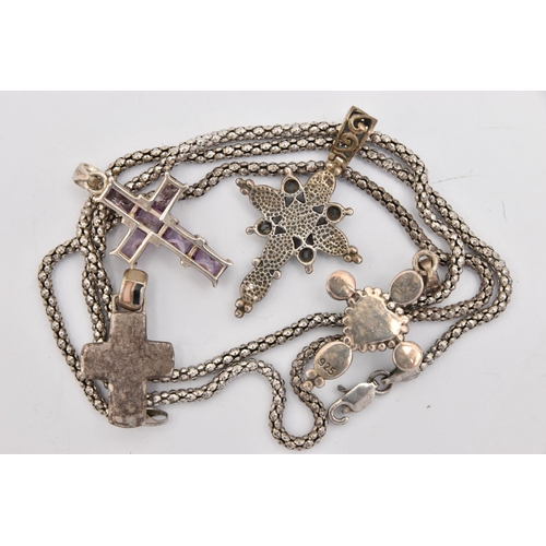 466 - FOUR WHITE METAL CROSS PENDANTS AND A CHAIN, crosses set with semi-precious gemstones to include cub... 