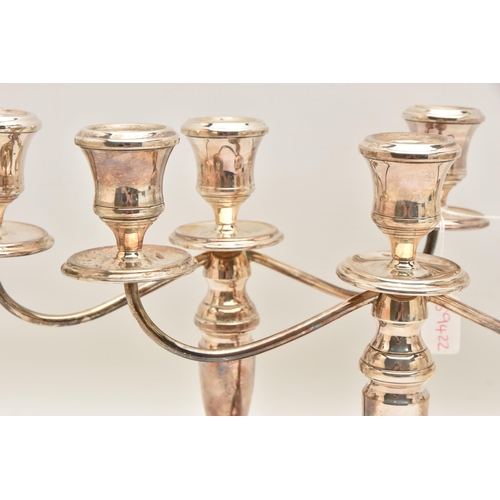 528 - A PAIR OF ELIZABETH II SILVER THREE BRANCH CANDLESTICKS, tapered stems on round weighted bases, hall... 