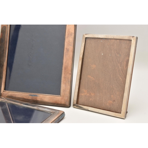 541 - FOUR SILVER PHOTO FRAMES, each of a rectangular form, three with a polished finish the other with a ... 