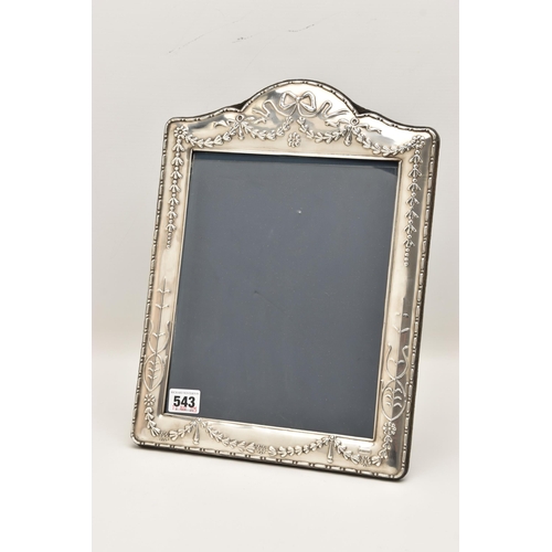 543 - A LARGE SILVER PHOTO FRAME, decorated with a bow and swag pattern, blue suede backing with easel, ha... 