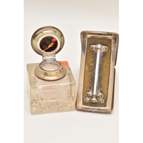 547 - A SILVER CASED THEMOMETER AND A GLASS INK WELL, the polished portable thermometer with engraved mono... 