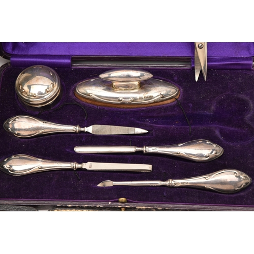 549 - AN ASSORTMENT OF CASED SILVER ITEMS, to include a cased silver travel manicure set, hallmarked 'W J ... 