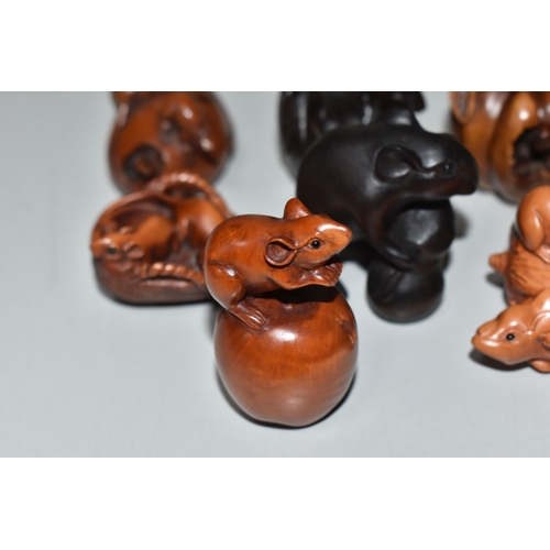 754 - SEVEN WOODEN NETSUKE, carved with rats, including rats clambering on and eating fruit and vegetables... 