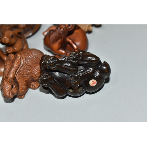 755 - EIGHT WOODEN NETSUKE, in the forms of various creatures, comprising a piglet riding a tortoise, a du... 