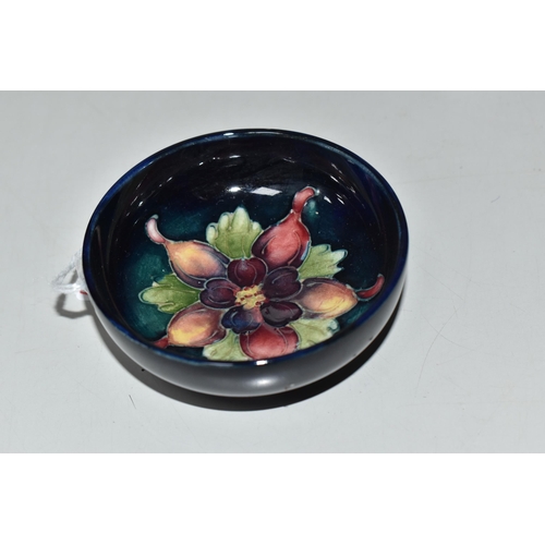 760 - A MOORCROFT POTTERY COLUMBINE FOOTED BOWL, tube-lined with a purple and yellow columbine flower on a... 