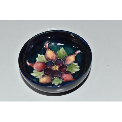 760 - A MOORCROFT POTTERY COLUMBINE FOOTED BOWL, tube-lined with a purple and yellow columbine flower on a... 