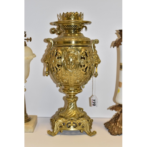 770 - THREE VICTORIAN OIL LAMP BASES, comprising a brass foliate design lamp base with lion mask handles, ... 