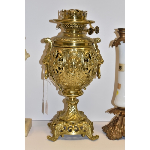 770 - THREE VICTORIAN OIL LAMP BASES, comprising a brass foliate design lamp base with lion mask handles, ... 