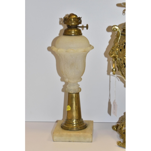 770 - THREE VICTORIAN OIL LAMP BASES, comprising a brass foliate design lamp base with lion mask handles, ... 