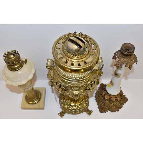 770 - THREE VICTORIAN OIL LAMP BASES, comprising a brass foliate design lamp base with lion mask handles, ... 