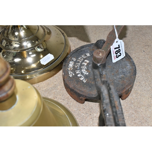 783 - A GROUP OF FOUR METAL ITEMS to include a brass bell with a wooden handle, a cast iron Rhythm No. 375... 