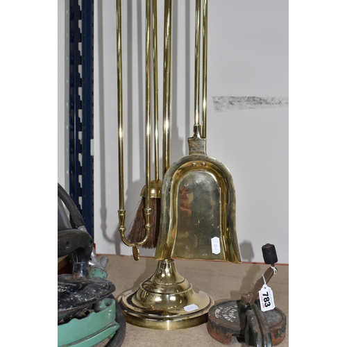 783 - A GROUP OF FOUR METAL ITEMS to include a brass bell with a wooden handle, a cast iron Rhythm No. 375... 