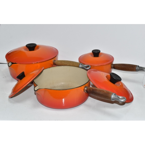 793 - THREE VINTAGE LE CREUSET PANS WITH TWO EXTRA LIDS in 'Volcanic Orange' colours all with wooden handl... 