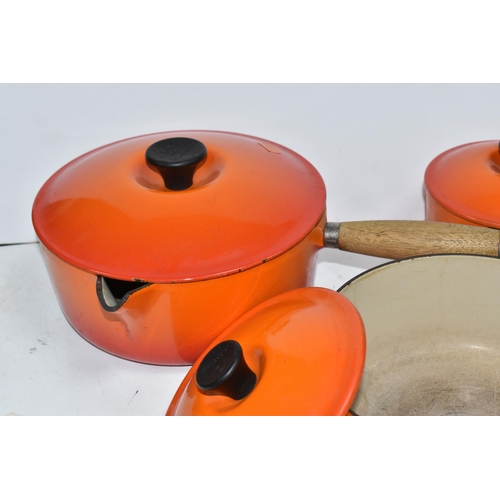 793 - THREE VINTAGE LE CREUSET PANS WITH TWO EXTRA LIDS in 'Volcanic Orange' colours all with wooden handl... 