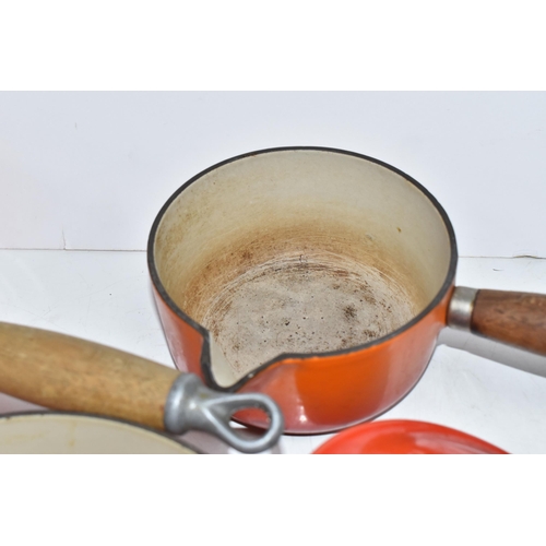 793 - THREE VINTAGE LE CREUSET PANS WITH TWO EXTRA LIDS in 'Volcanic Orange' colours all with wooden handl... 