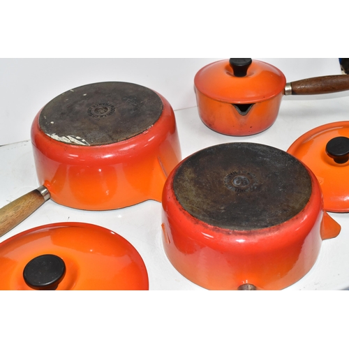 793 - THREE VINTAGE LE CREUSET PANS WITH TWO EXTRA LIDS in 'Volcanic Orange' colours all with wooden handl... 