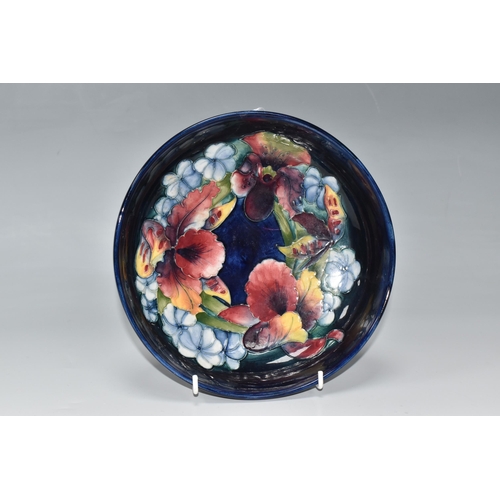 814 - A MOORCROFT POTTERY 'ORCHID' PATTERN FOOTED BOWL, tube-lined with a ring of red, yellow and purple o... 