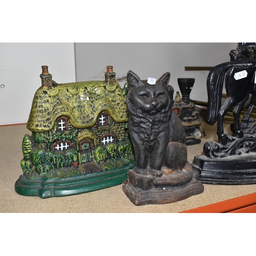 827 - A GROUP OF CAST IRON DOOR STOPS to include a pair of opposite facing black painted horses door stops... 