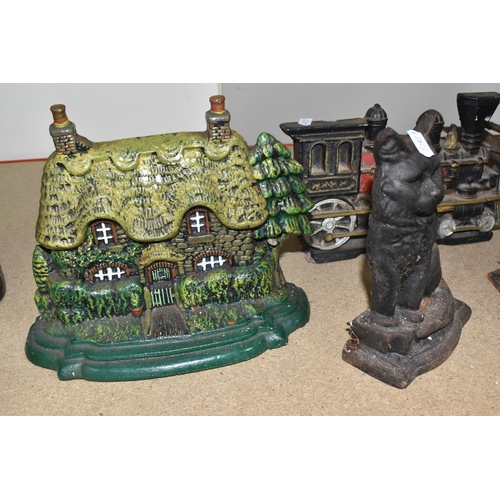 827 - A GROUP OF CAST IRON DOOR STOPS to include a pair of opposite facing black painted horses door stops... 