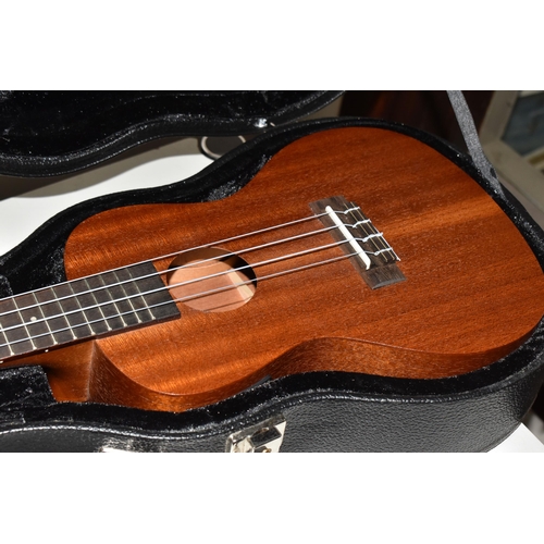 851 - A UKELELE AND A 3/4 SIZE LEFT-HANDED GUITAR, both have cases, comprising a Laka ukelele with built i... 