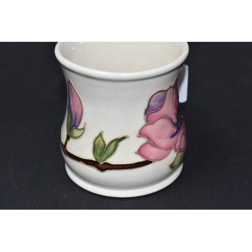 873 - A MOORCROFT POTTERY FOR LIBERTY MUG, tube lined with pink magnolia flowers on a branch, and dated 19... 