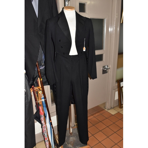 914 - THREE EARLY/MID CENTURY GENTLEMEN'S MORNING SUITS TOGETHER WITH A COLLECTION OF WALKING STICKS AND U... 