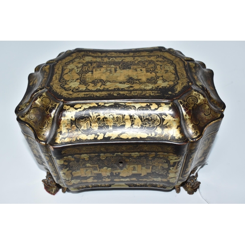 918 - A GILDED CHINOISERIE TEA CADDY with two engraved pewter canisters to the interior, raised on 'dragon... 