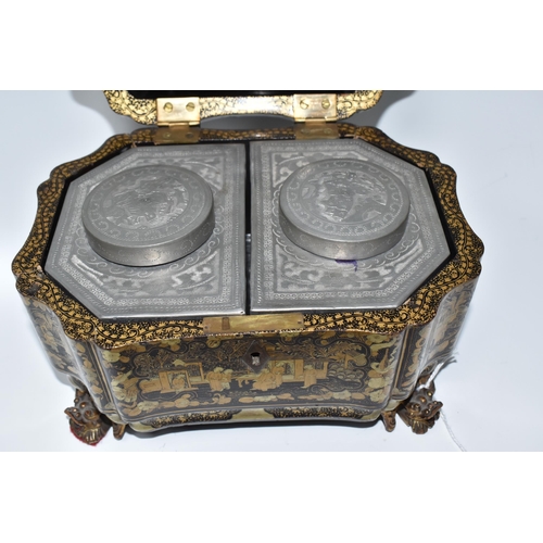 918 - A GILDED CHINOISERIE TEA CADDY with two engraved pewter canisters to the interior, raised on 'dragon... 