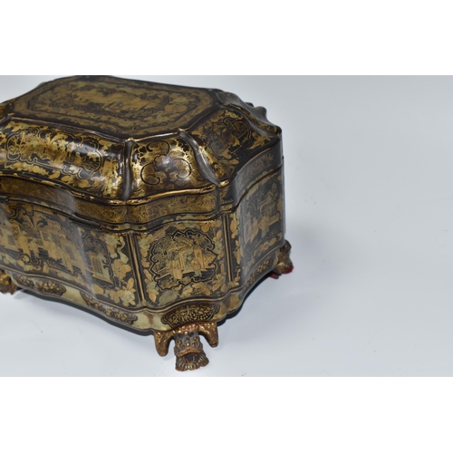 918 - A GILDED CHINOISERIE TEA CADDY with two engraved pewter canisters to the interior, raised on 'dragon... 