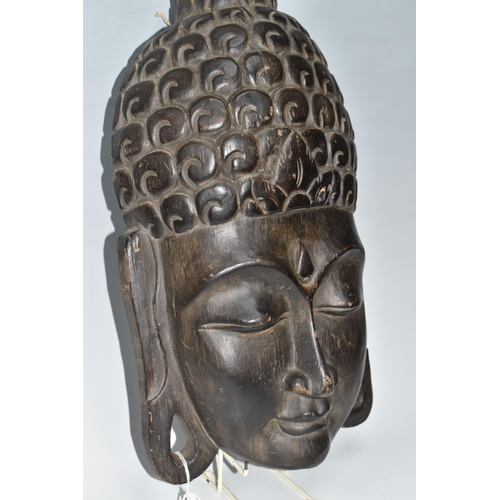 919 - A LARGE BUDDHA'S HEAD WALL PLAQUE depicting a young Buddha in a meditative state, hair curls to the ... 