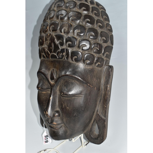 919 - A LARGE BUDDHA'S HEAD WALL PLAQUE depicting a young Buddha in a meditative state, hair curls to the ... 