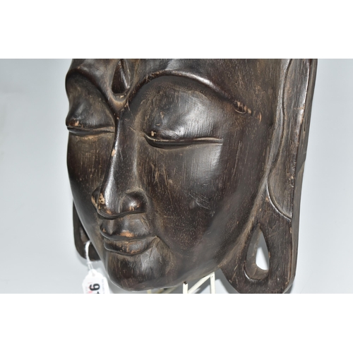 919 - A LARGE BUDDHA'S HEAD WALL PLAQUE depicting a young Buddha in a meditative state, hair curls to the ... 