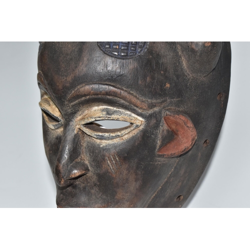 922 - A PUNE TRIBAL MASK, GABON with naturally pigmented horns with an anthropomorphic crest to the forehe... 