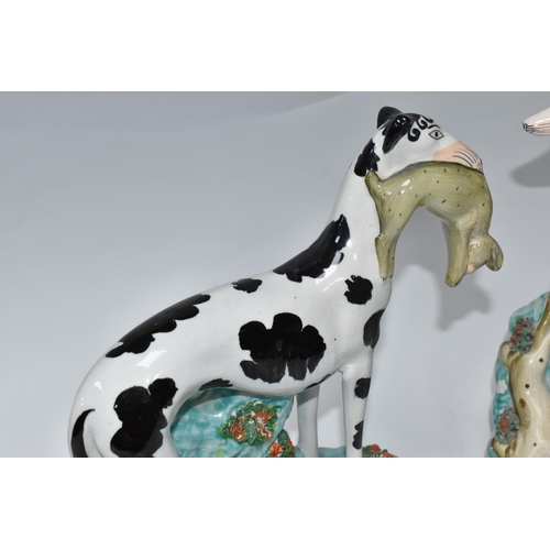 924 - A PAIR OF STAFFORDSHIRE 'DISRAELI CURL' GREYHOUND FIGURES comprising a left and right facing hound, ... 