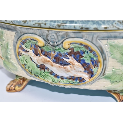 925 - A MINTON MAJOLICA LIDDED GAME PIE TUREEN with a moulded gundog handle to the lid, with two twisted h... 