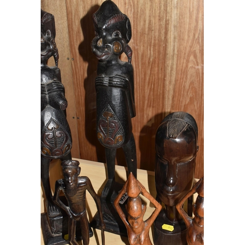 932 - A GROUP OF MOSTLY MID TWENTIETH CENTURY WEST AFRICAN WOODEN SCULPTURES comprising a pair of two knee... 