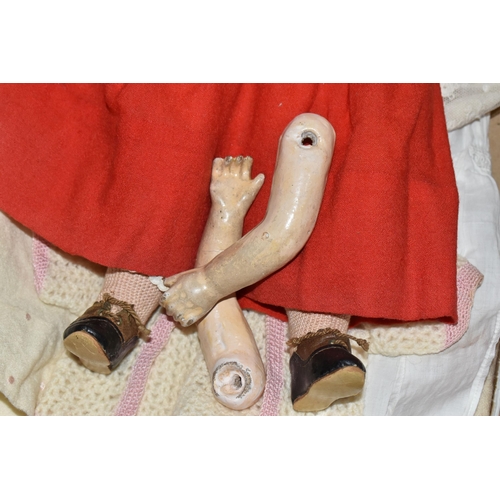 933 - A GERMAN BISQUE HEAD DOLL AND CLOTHES, the doll has an open mouth with four teeth showing, painted l... 