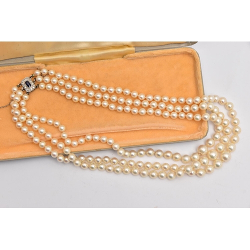 583 - A THREE STRAND CULTURED PEARL NECKLACE, three strands of individually knotted, graduated cream pearl... 