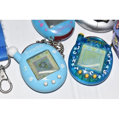 757 - A BOX OF TAMAGOTCHIS AND A POKE WALKER, four of the Tamagotchis and the Poke Walker are in working c... 