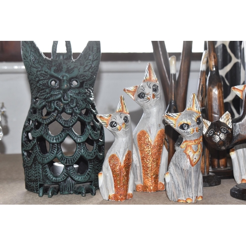 860 - A COLLECTION OF CAT FIGURES, thirteen mostly wooden, tallest approximately 69cm, together with a han... 