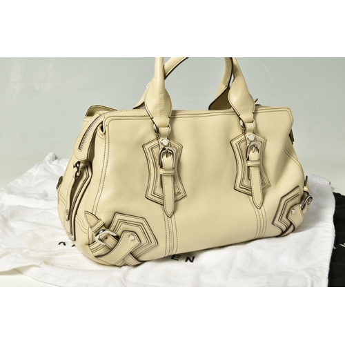 586 - KAREN MILLEN: TWO LEATHER HANDBAGS: a tan leather handbag with removable shoulder strap, silver tone... 