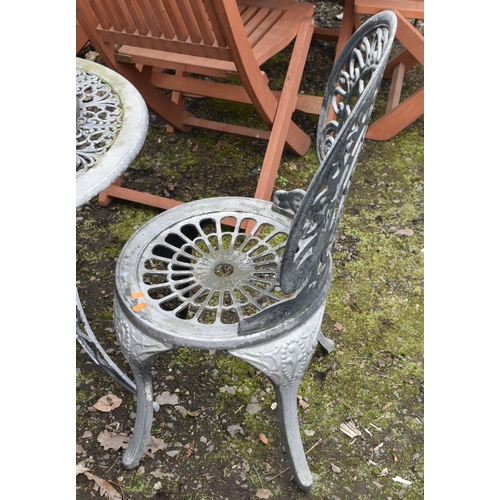18 - AN OVERPAINTED CAST ALUMINIUM GARDEN TABLE, diameter 65cm x height 62cm, two chairs and a cast iron ... 