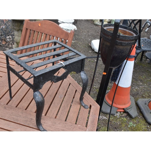 27 - A CAST IRON TRIVET, along with a wrought iron strap work plant stand with a glazed planter, height 1... 