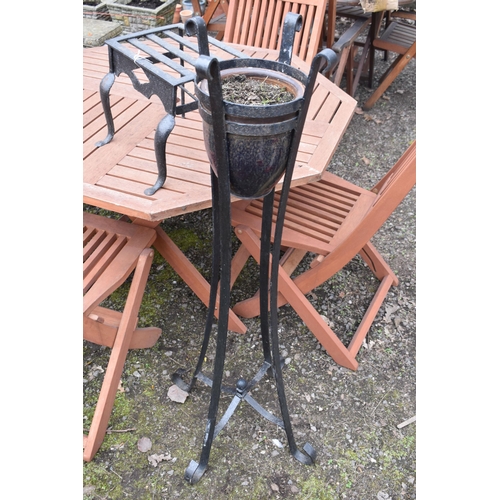 27 - A CAST IRON TRIVET, along with a wrought iron strap work plant stand with a glazed planter, height 1... 