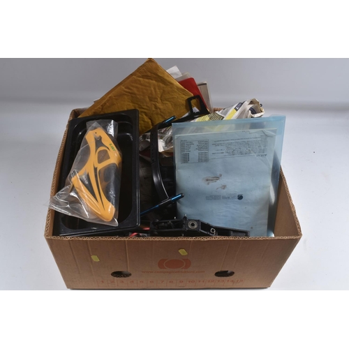 174 - SIX TRAYS CONTAINING RC HELICOPTER PARTS including nose cones, tail rods, rotors, engine parts, manu...